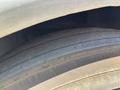 Close-up of a tire from a 2018 Grande West Vicinity showing tread patterns and surface details