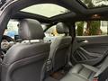Interior view of a 2016 Mercedes-Benz GLA-250 showcasing leather seats and a panoramic sunroof