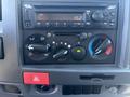 Dashboard controls of a 2022 Isuzu NQR including audio system and climate control knobs