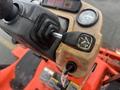 Close-up of the control panel and ignition key of a 2010 Kubota F3680 tractor featuring gauges and a gear shift lever
