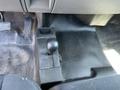 Interior view of a 2013 Chevrolet Silverado 1500 showing the floor console shift lever and the surrounding area