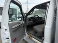2004 Ford F-350 SD with an open driver's door revealing a gray interior and seats with minimal details visible inside