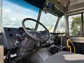 Interior view of a 2017 Freightliner MT45 with a steering wheel dashboard controls and a driver's seat visible