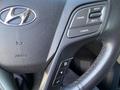Close-up of the steering wheel of a 2018 Hyundai Santa Fe showing controls for cruise control and audio settings