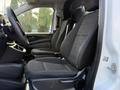 Interior view of a 2020 Mercedes-Benz Metris showing the front seats with fabric upholstery and a steering wheel visible