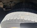 A close-up of a tire from a 2012 Ford Econoline showing tread patterns and rubber texture
