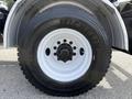 Close-up view of the wheel of a 2016 Freightliner 108SD with a Michelin tire showcasing the tread and black rim