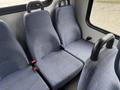 Interior view of a 2018 Chevrolet Express showing three blue fabric seats with black armrests and seatbelts