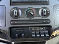 Dashboard controls of a 2009 Ford F-550 featuring climate controls knobs and multiple switches for various functions