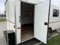 A 2025 Shuttle Office with an open door revealing a spacious interior and a wooden floor