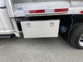 A silver tool box mounted on the side of a 2016 RAM 5500 truck with two handles for opening