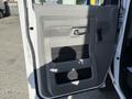 The image shows the interior driver's side door of a 2021 Ford Econoline featuring a gray panel with a handle and window controls