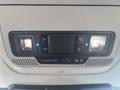 Interior overhead console of a 2023 Ford F-350 SD featuring buttons and indicators for lights and airbags