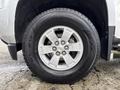 Close-up of a silver 2018 Chevrolet Colorado wheel with a five-spoke alloy rim and a black tire featuring a tread pattern