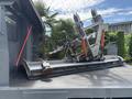 A 2016 RAM 5500 with a mounted hydraulic lift attachment in a metallic finish positioned on the back of the truck