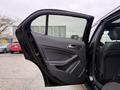 A 2016 Mercedes-Benz GLA-250 with the rear door open showcasing the interior door panel and handle