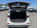 Rear view of a 2018 Hyundai Santa Fe with the trunk open showing a spacious cargo area without any items inside