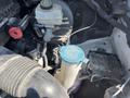 A 2016 Mercedes-Benz Sprinter engine bay with various components including coolant reservoir a hose and an ECU unit
