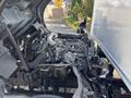A 2018 Hino 195 truck with its engine exposed showcasing various mechanical components and connections arranged within the engine bay