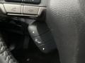 Close-up of the steering wheel controls in a 2016 Subaru Forester showing buttons for adjusting settings