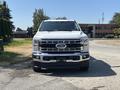 A 2023 Ford F-350 Super Duty pickup truck facing forward with a shiny chrome grille and large headlights
