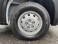 A close-up view of a 2023 RAM Promaster 3500 wheel featuring a silver rim and black tire with a tread pattern visible
