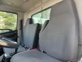 Interior of a 2012 Hino 338 showing two grey fabric seats and a steering wheel in the foreground