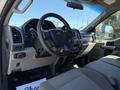 Interior of a 2019 Ford F-350 SD featuring a steering wheel dashboard and seats with a focus on the driver side controls