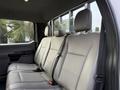 Interior seating of a 2020 Ford F-550 showing a clean gray leather bench seat with headrests and seat belts