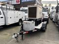 A 2005 Trailerman Generator Trailer with a large generator unit on top and a storage box at the front mounted on a black trailer chassis