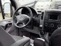 Interior view of a 2017 Mercedes-Benz Sprinter showing the steering wheel dashboard and gear shift with various controls and displays visible