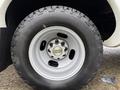 Close-up of a silver wheel with a Chevrolet emblem and rugged black tire on a 2013 Chevrolet Express