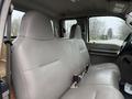 Interior view of a 2008 Ford F-250 SD featuring a spacious gray leather bench seat with two headrests and seat belts