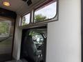 Interior view of a 2007 Ford F-550 showing the driver's seat and door opening with windows above