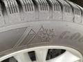 Close-up of a tire tread featuring the Goodyear logo and a winter tire icon with a snowflake and mountain design on a 2017 Ford Edge