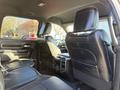 Interior view of a 2023 RAM 3500 featuring black leather seats with a spacious back seating area and modern design elements