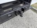 Close-up of the rear hitch on a 2021 Freightliner M2 106 featuring a black metal structure with a towing hook attached