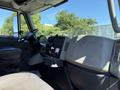 Interior view of a 2013 International 7400 featuring a driver's seat dashboard controls and steering wheel