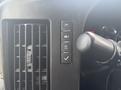 2020 Chevrolet Express dashboard controls with buttons for lights indicators and settings next to a vent and a steering column lever