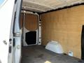 Interior of a 2022 Mercedes-Benz Sprinter van showing a spacious cargo area with wooden paneling and a low storage compartment on the floor