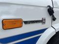 Close-up of a 1994 GMC Vandura 3500 badge with the text "Vandura" and "3500" alongside an orange side marker light