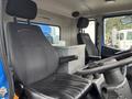 Interior view of a 2017 Autocar Xpert showing two black leather seats with headrests and a center console box between them