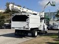A 2019 Freightliner M2 106 bucket truck featuring a large elevated boom and a white exterior with rear storage compartments