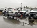 A 2009 ShoreLandr ANDER boat trailer with a black frame and red accents is parked among vehicles in a lot