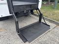 A flatbed truck ramp extended from the back of a 2021 RAM 5500 aimed at facilitating the loading and unloading of cargo