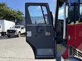 A 1992 Emergency One Typhoon Superior fire truck with an open driver's side door revealing the interior controls and dashboard