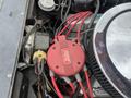Close-up of a red ignition coil and wires in the engine compartment of a 1970 Chevrolet Corvette