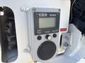 A gray control panel with a digital display and buttons labeled "SELF TEST," "ADJUST," and "SETPOINT" mounted on a vehicle