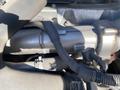 Close-up of a 2019 Hino 195 engine component featuring metal tubing and hoses connecting various parts of the engine