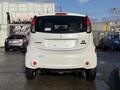 A white 2012 Mitsubishi I-MiEV viewed from the rear showcasing its compact design and unique taillight shapes